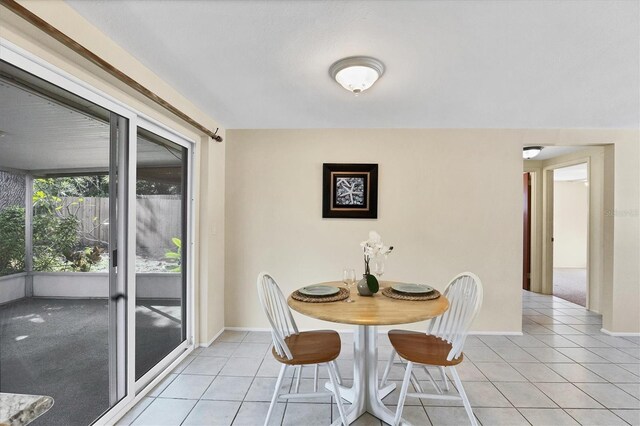 dining area featuring light tile patterned floors and baseboards