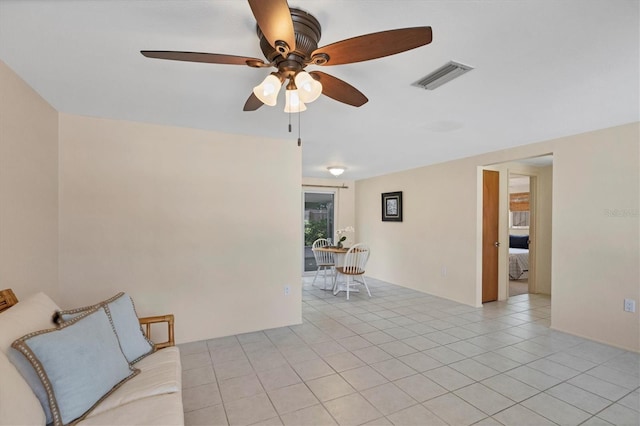 unfurnished living room featuring light tile patterned flooring and ceiling fan