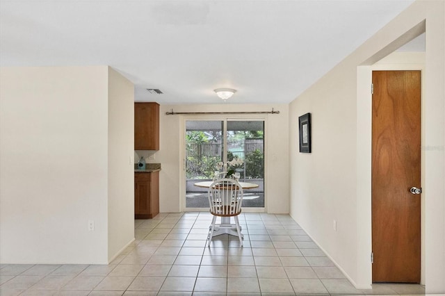 unfurnished dining area featuring light tile patterned floors