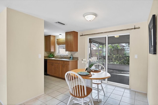 dining area with sink and light tile patterned flooring