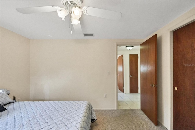 bedroom featuring light colored carpet and ceiling fan