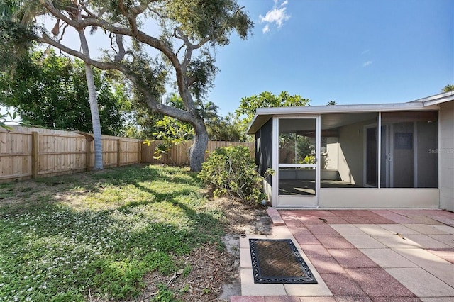 view of yard with a patio area and a sunroom