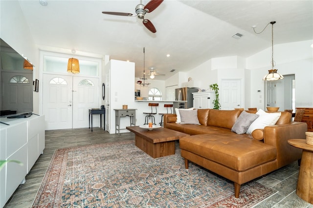 living room with dark wood-type flooring, ceiling fan, and lofted ceiling