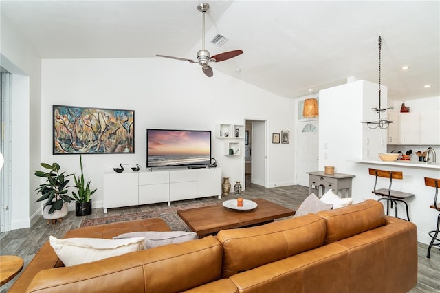 living room with vaulted ceiling, wood-type flooring, and ceiling fan