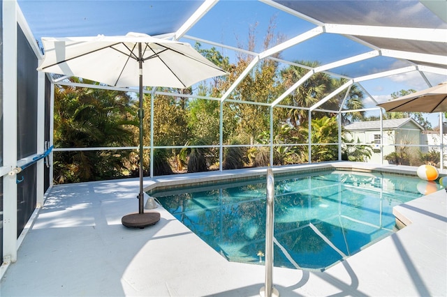 view of pool with a patio area and a lanai