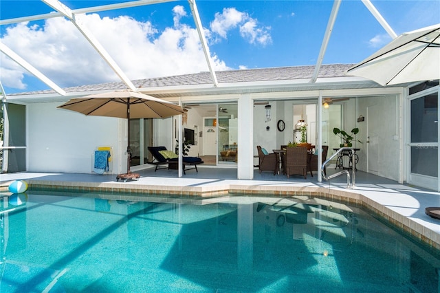 view of swimming pool featuring a patio and a lanai