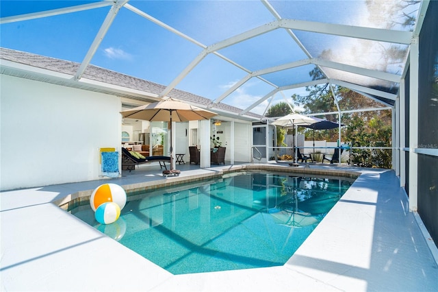 view of swimming pool with a patio area and glass enclosure