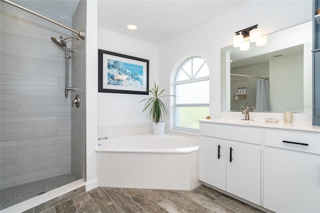 bathroom featuring vanity and shower with separate bathtub