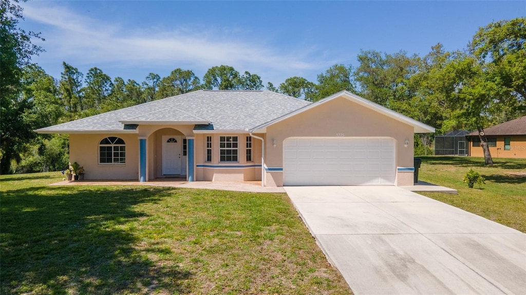 ranch-style house featuring a front yard and a garage