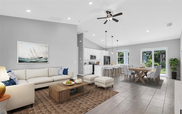 tiled living room featuring high vaulted ceiling and ceiling fan