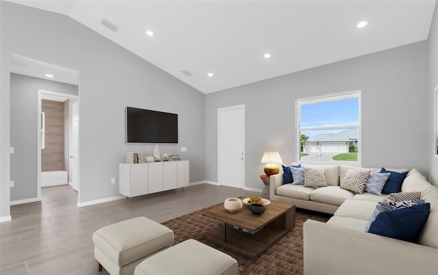 living room featuring hardwood / wood-style flooring and lofted ceiling