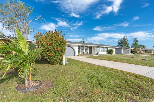 view of front of property with a front yard and a garage