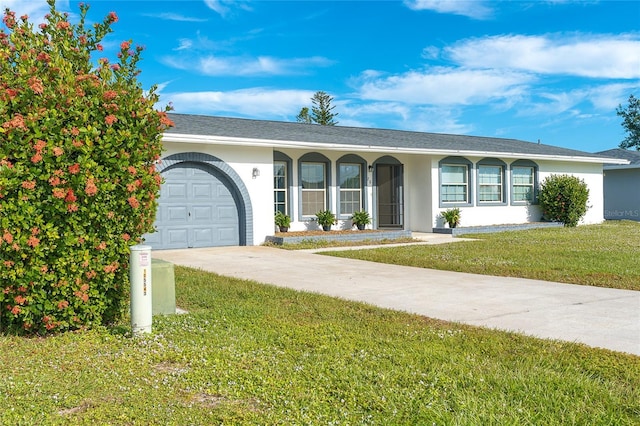 20 Annapolis Ln, Rotonda West, FL 33947 - ranch-style house with an attached garage, driveway, a front yard, and stucco siding