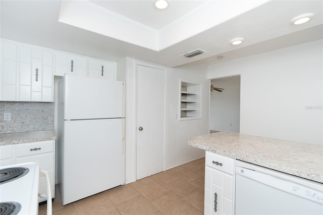 kitchen with a raised ceiling, white cabinetry, and white appliances