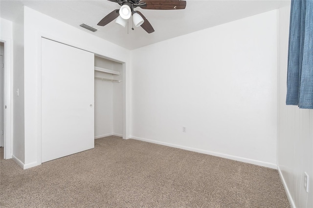 unfurnished bedroom featuring carpet flooring, ceiling fan, and a closet