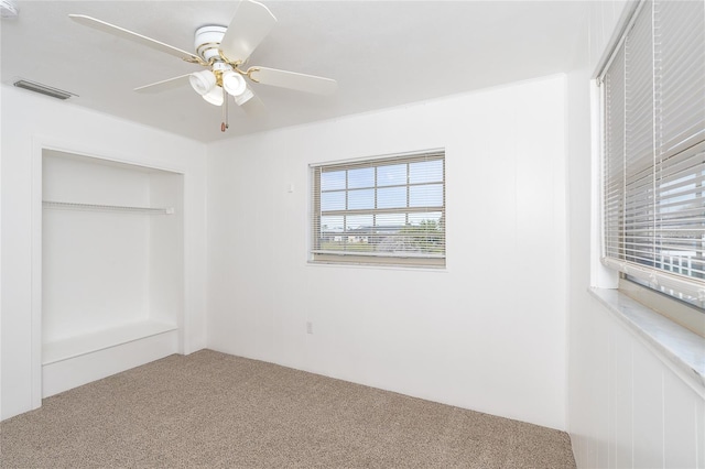 unfurnished bedroom featuring carpet, ceiling fan, and a closet