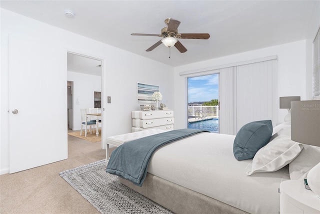 bedroom with light carpet, access to outside, and ceiling fan