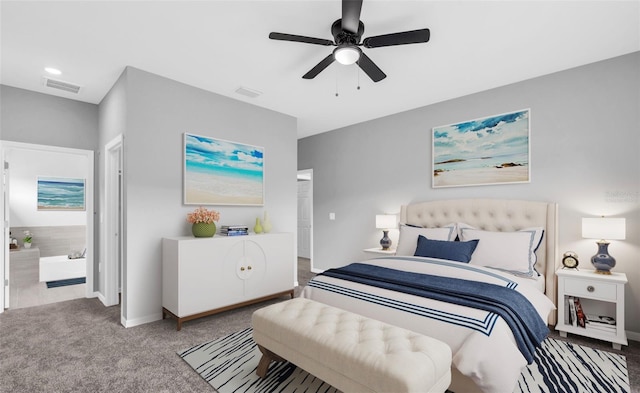 bedroom with ensuite bathroom, carpet floors, and ceiling fan