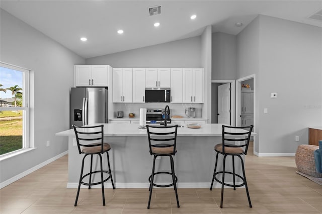 220 Mark Twain Ln, Rotonda West, FL 33947 - kitchen featuring a sink, appliances with stainless steel finishes, a center island with sink, and light countertops