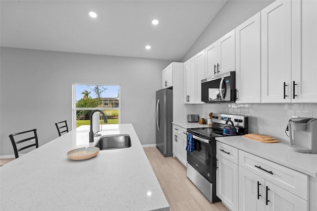 220 Mark Twain Ln, Rotonda West, FL 33947 - kitchen with tasteful backsplash, a sink, stainless steel appliances, recessed lighting, and white cabinetry