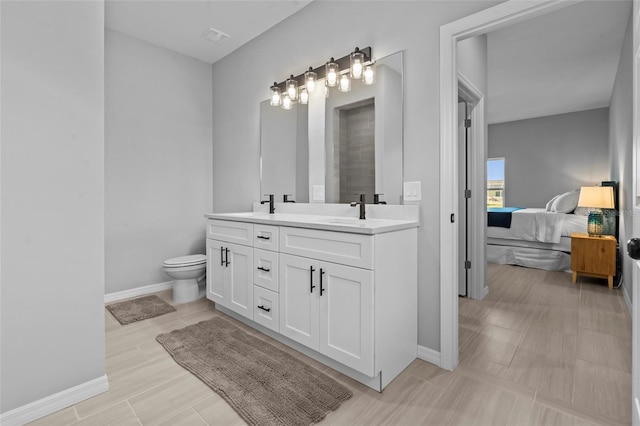 220 Mark Twain Ln, Rotonda West, FL 33947 - ensuite bathroom with a sink, baseboards, double vanity, and connected bathroom