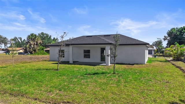 220 Mark Twain Ln, Rotonda West, FL 33947 - rear view of property with a lawn, roof with shingles, and stucco siding