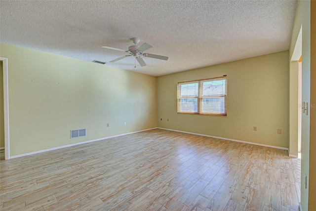 empty room with light hardwood / wood-style floors, a textured ceiling, and ceiling fan