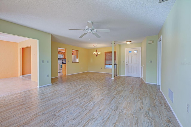 612 Deerwood Ave Unit 169, Englewood, FL 34223 - unfurnished living room featuring a chandelier, ceiling fan, light wood-style floors, a textured ceiling, and baseboards