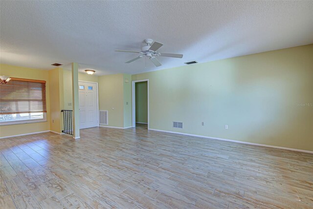 612 Deerwood Ave Unit 169, Englewood, FL 34223 - empty room featuring a textured ceiling, light wood finished floors, baseboards, and a ceiling fan