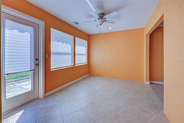 unfurnished sunroom featuring ceiling fan