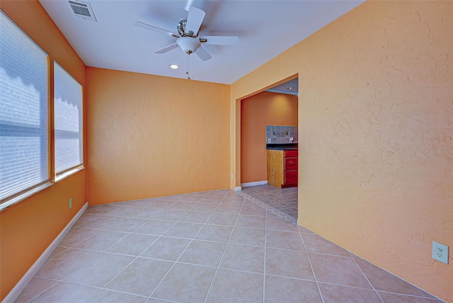 spare room featuring ceiling fan and light tile patterned floors