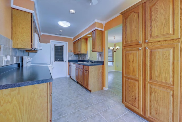 kitchen with white appliances, backsplash, crown molding, and sink