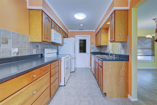 kitchen with light hardwood / wood-style flooring, sink, crown molding, white appliances, and tasteful backsplash