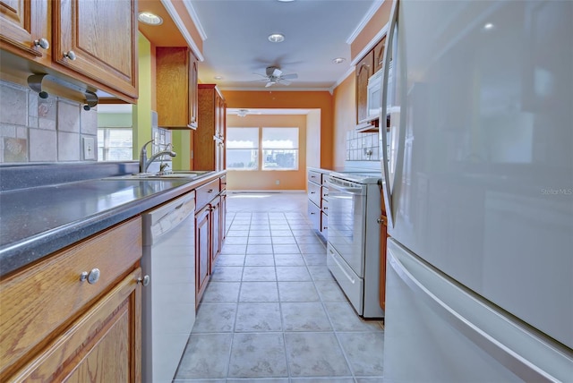 kitchen featuring backsplash, ornamental molding, sink, light tile patterned flooring, and white appliances