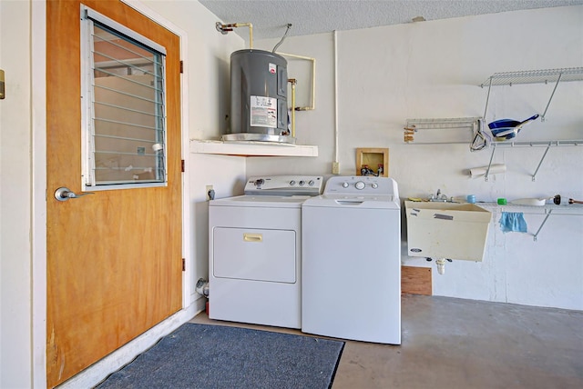 washroom featuring sink, electric water heater, independent washer and dryer, and a textured ceiling