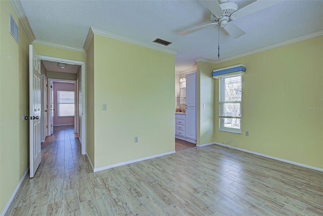 unfurnished room with light hardwood / wood-style floors, ornamental molding, and ceiling fan