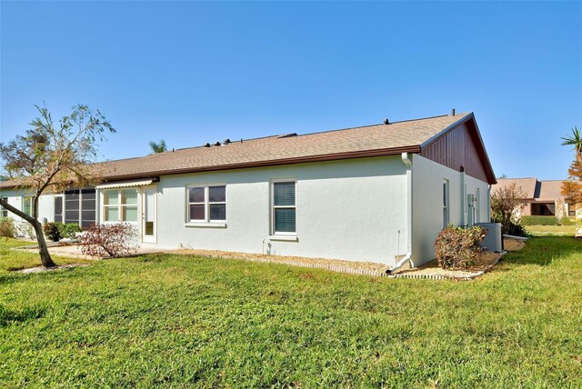 612 Deerwood Ave Unit 169, Englewood, FL 34223 - back of property featuring a yard, stucco siding, and central AC