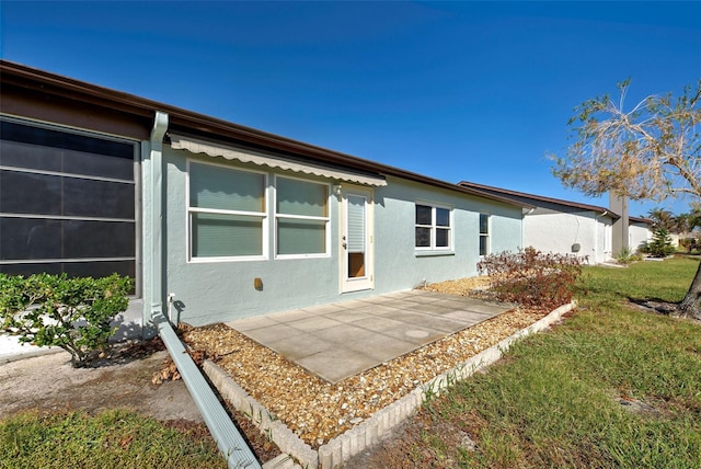 612 Deerwood Ave Unit 169, Englewood, FL 34223 - rear view of house featuring stucco siding and a patio