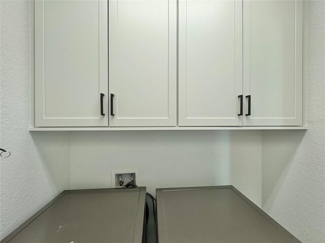19060 Moscato Ct, Venice, FL 34293 - laundry area featuring cabinet space, washer hookup, a textured wall, and a desk