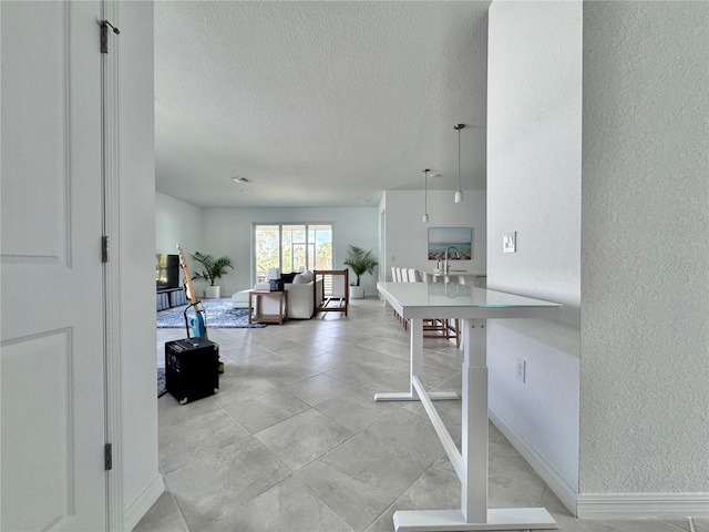 interior space featuring sink and a textured ceiling