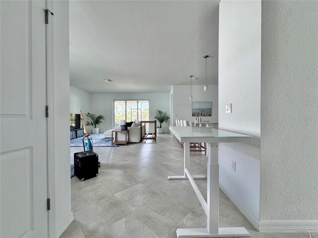 19060 Moscato Ct, Venice, FL 34293 - interior space with a textured ceiling, baseboards, a textured wall, and a sink