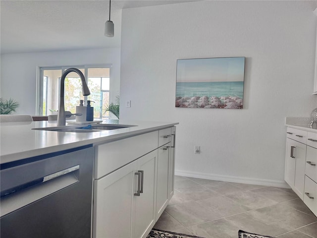 kitchen featuring white cabinets, hanging light fixtures, dishwashing machine, light tile patterned flooring, and sink