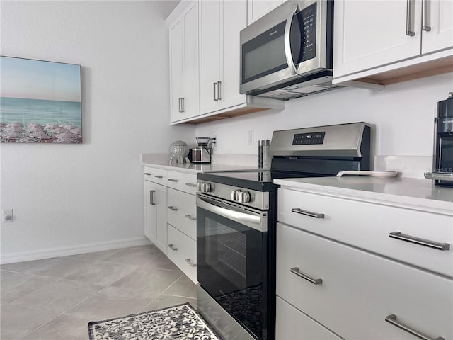 kitchen featuring white cabinetry, appliances with stainless steel finishes, and light tile patterned floors