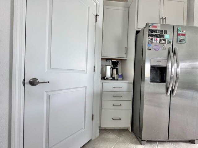 19060 Moscato Ct, Venice, FL 34293 - kitchen with stainless steel refrigerator with ice dispenser, light tile patterned floors, and light countertops