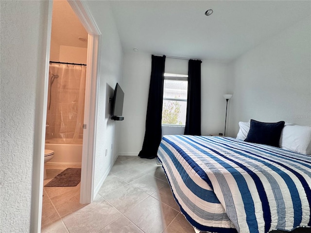 tiled bedroom featuring ensuite bath