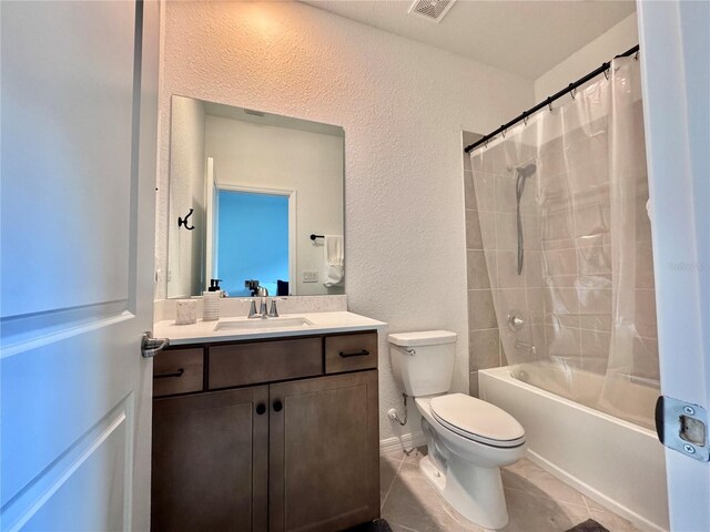 19060 Moscato Ct, Venice, FL 34293 - bathroom featuring toilet, a textured wall, vanity, shower / tub combo, and tile patterned floors