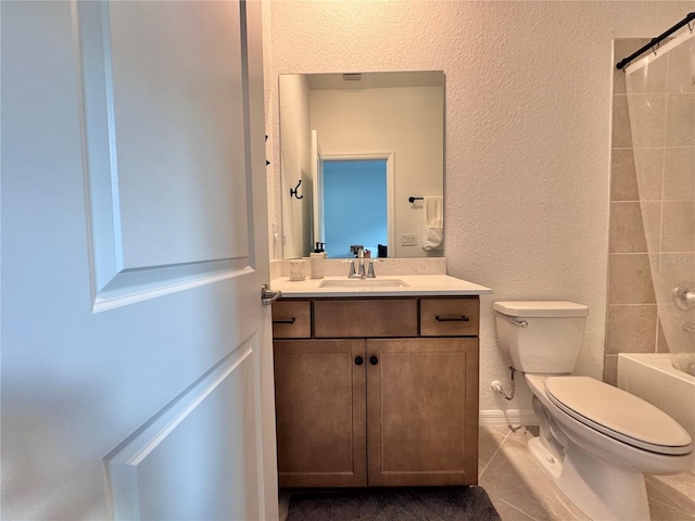 full bathroom with vanity, tiled shower / bath combo, toilet, and tile patterned flooring