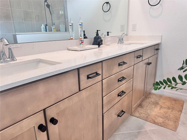 bathroom featuring vanity, a tile shower, and tile patterned floors