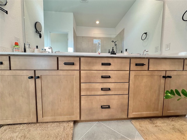 bathroom with vanity, walk in shower, and tile patterned flooring