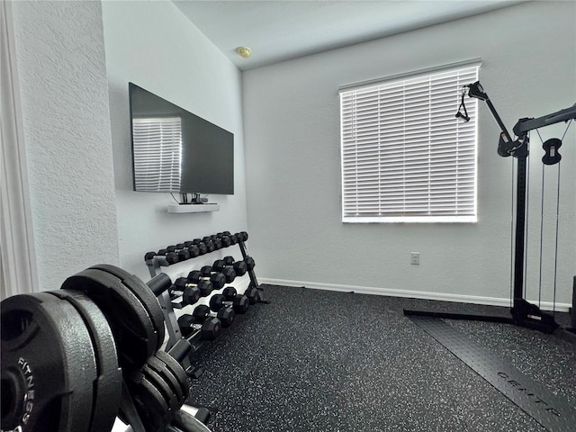 19060 Moscato Ct, Venice, FL 34293 - workout area featuring baseboards and a textured wall
